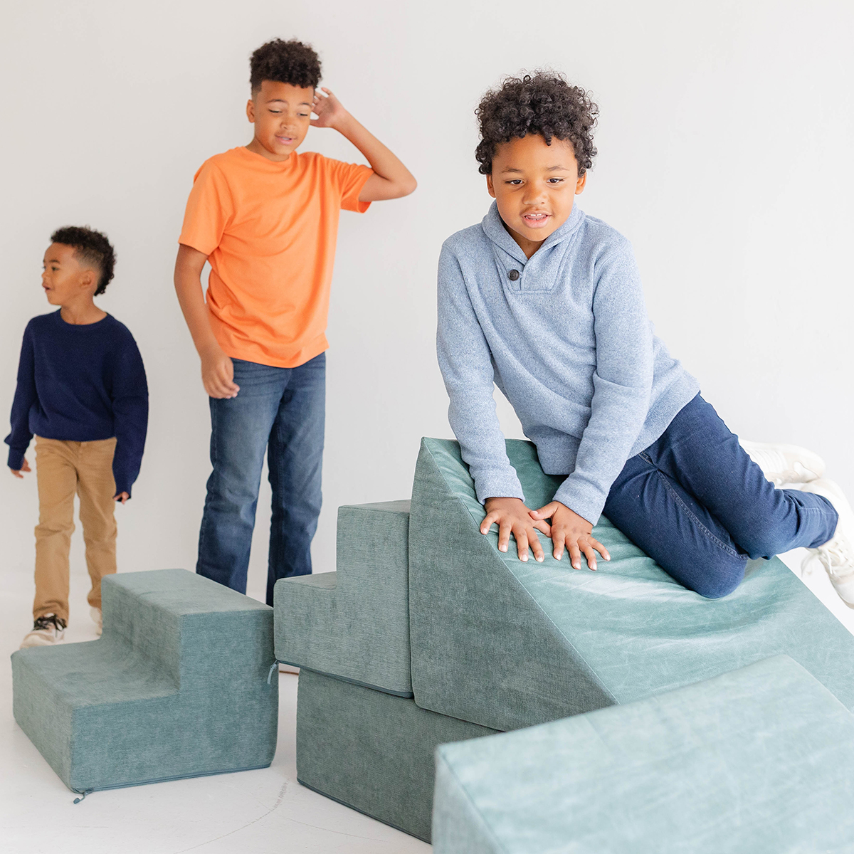 Sulo Syringe Caddy: Children playing and climbing on foam blocks in a bright, safe room.