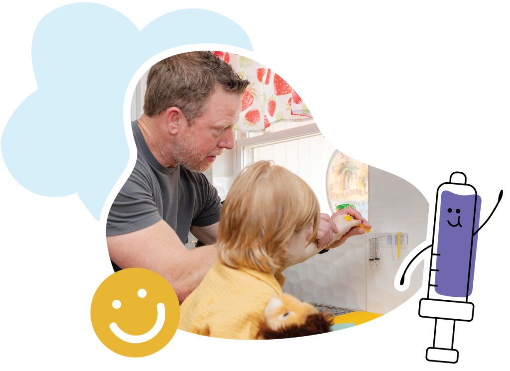 Father helping child insert a syringe into a wall-mounted Syringe Storage Caddy in the kitchen.