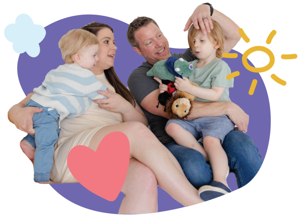 Smiling family with two young children playing together with toys showing the values in this family-owned business.